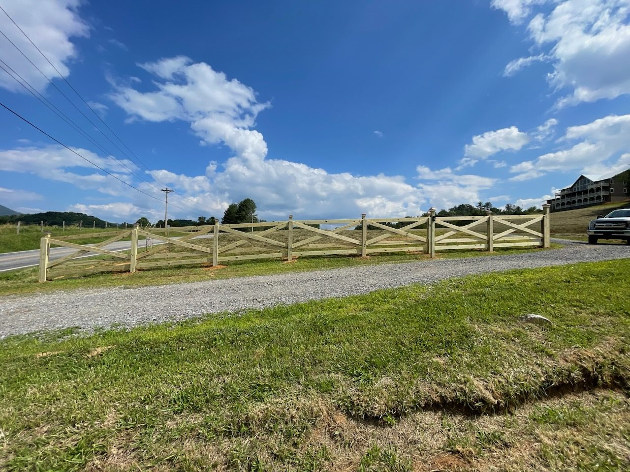 Wood pasture fence along a gravel road in the mountains